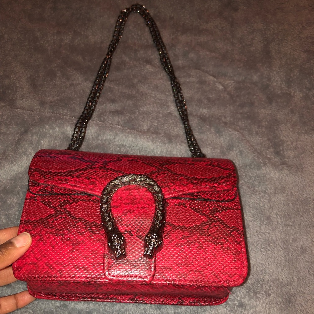 Red snake skin handbag